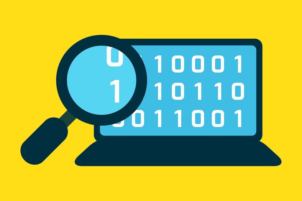 A magnifier glass looking at binary code on a laptop